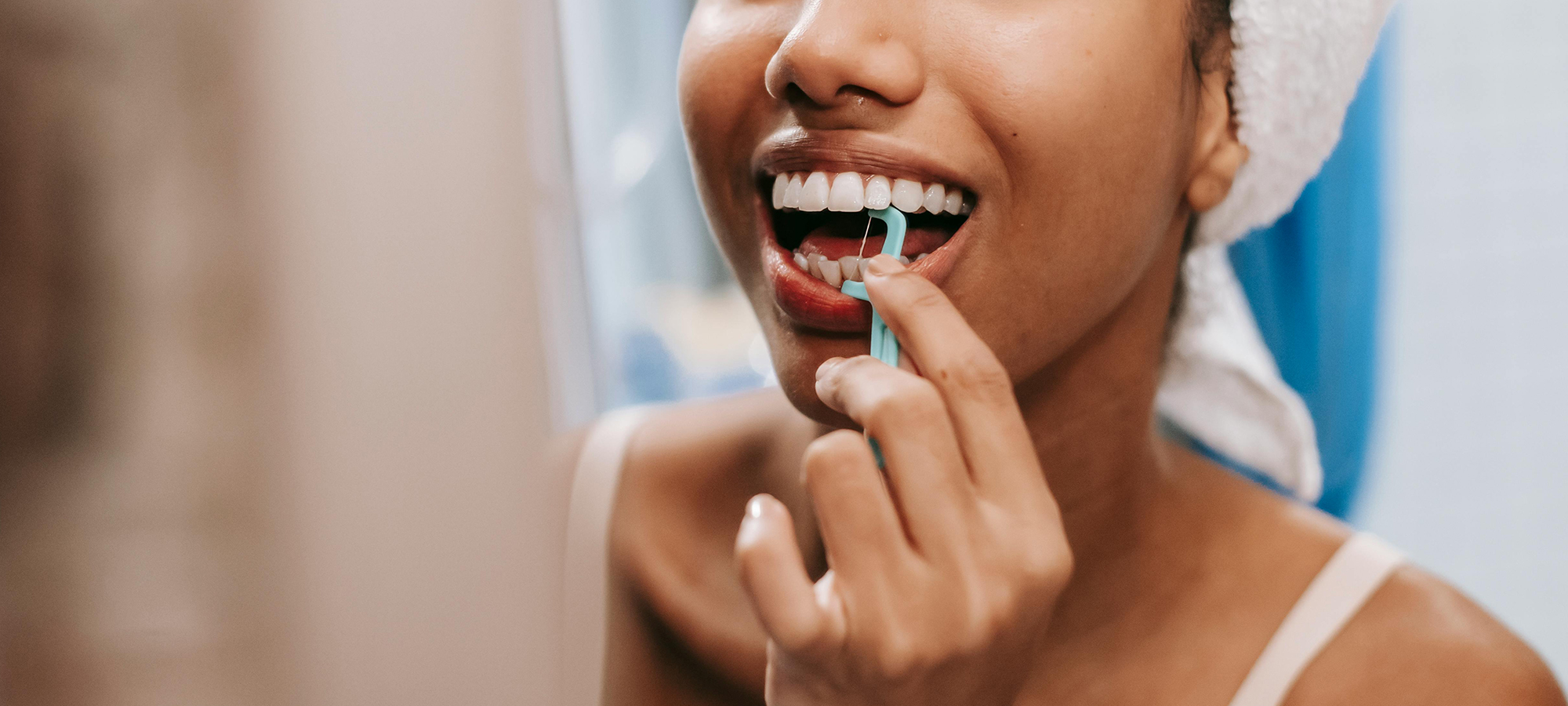 Woman flossing teeth