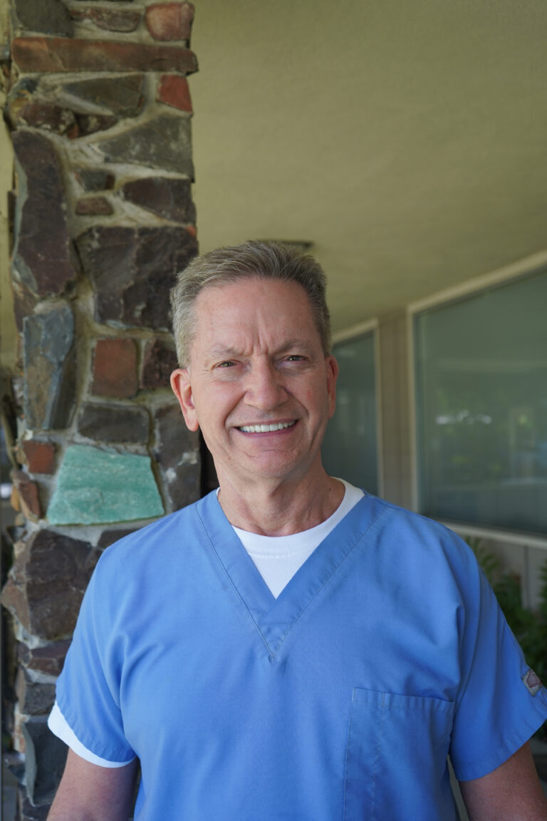 Dr. John Vellquette smiling in his office at Smile Center Silicon Valley